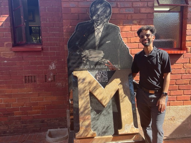 A Nelson Mandela cut-out sculpture and a large stone letter M outside his brick house in Soweto